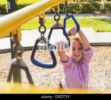 Boy (8-9) playing on playground, Jupiter, Florida, USA Stock Photo