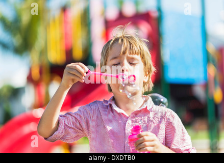 Boy (8-9) blowing bubbles, Jupiter, Florida, USA Stock Photo