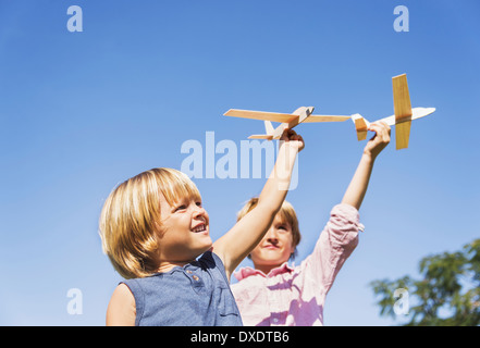 Boys (4-5, 8-9) playing with airplane toys Stock Photo