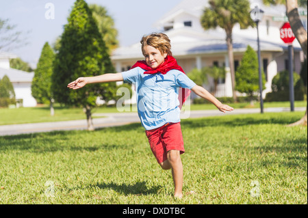 Boy (8-9) running with cape, Jupiter, Florida, USA Stock Photo