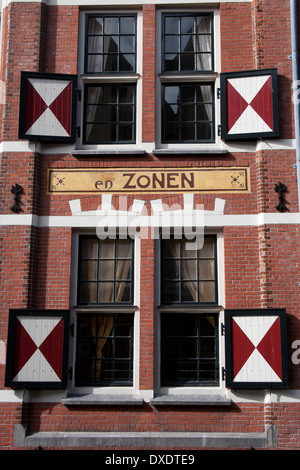 Window with red and white open shutters on the front of a traditional canal house Amsterdam the Netherlands Stock Photo