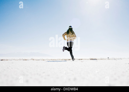 Woman running on snow, Colorado, USA Stock Photo