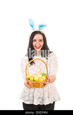 Happy woman with bunny ears giving Easter basket isolated on white background Stock Photo