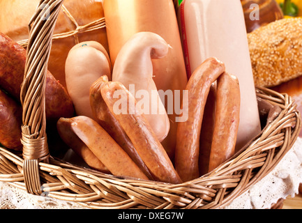 Variety of sausage products in the basket. Close-up shot. Stock Photo