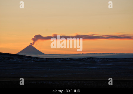 Sunset with steam from the Shishaldin Volcano on Unimak Island in the Alaska Maritime National Wildlife Refuge January 1, 2009 in the Aleutian Islands, Alaska. Stock Photo