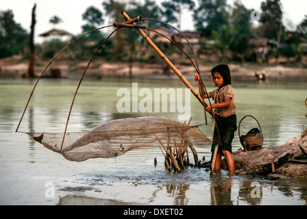 Laos children fishing net bamboo poles riverbank trees sunshine