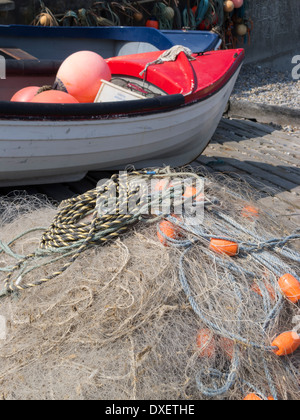 small fishing boat with nets in foreground Sheringham Norfolk England Stock Photo