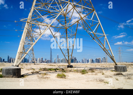 Skyline of Dubai with high-voltage electricity transmission pylons in United Arab Emirates Stock Photo