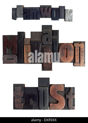 Words teamwork, motivation, trust written in vintage letterpress type, scratched and stained, isolated on white background Stock Photo