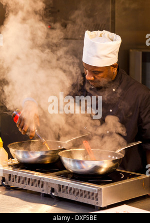 Chef cooking in the famous indoor market Grainger Market in Newcastle upon Tyne city Tyne and Wear Tyneside England UK GB EU Stock Photo