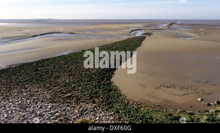 View from Jenny Brown's Point, nr Silverdale, Lancs, UK of rubble embankment in Morecambe Bay. Stock Photo