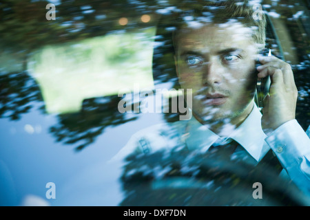 Businessman using Cell Phone and Driving, Mannheim, Baden-Wurttemberg, Germany Stock Photo