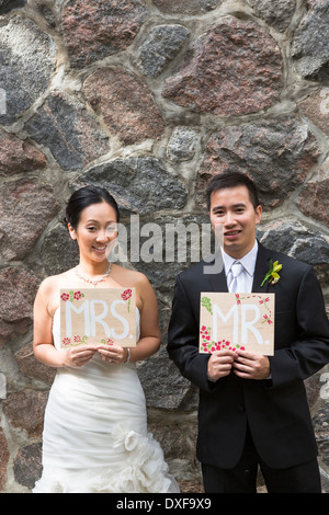 Portrait of Married Couple with Mr and Mrs Signs Stock Photo