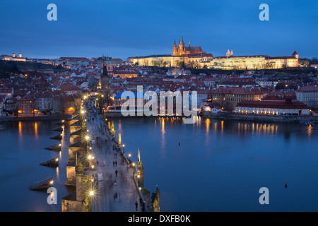 the Charles Bridge over the Vltava River at dusk with the Castle District and St Vitus's Cathedral beyond Prague Czech Republic Stock Photo