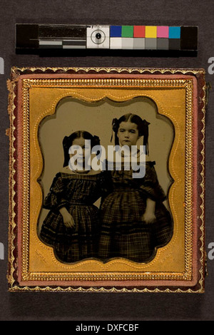 Portrait of two girls in matching dresses Portrait of two girls in matching dresses Stock Photo