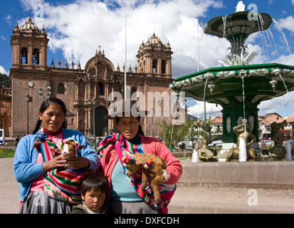 Local people by the Cathedral in the Plaza de Armas in Cuzco in Peru Stock Photo