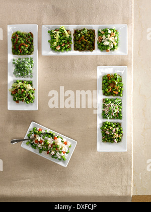 Variety of ways to serve peas in white dishes, studio shot Stock Photo