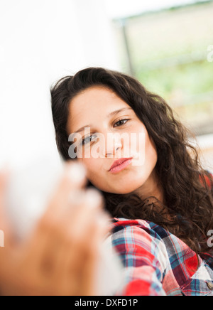 Teenage girl posing and taking selfie with smart phone, Germany Stock Photo