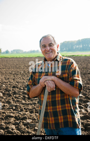 Portrait of farmer standing and working in field, Germany Stock Photo