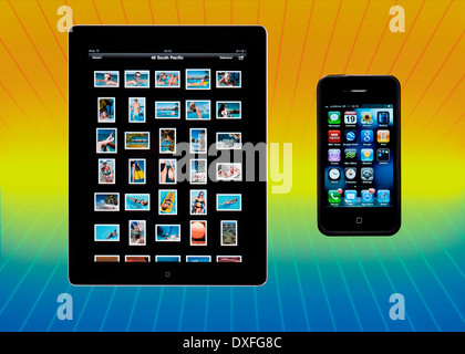 An Apple iPad2 showing the photo library and an iPhone4 showing the Apps display. Stock Photo