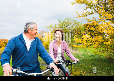 Couple Riding Bicycles in Autumn, Mannheim, Baden-Wurttemberg, Germany Stock Photo