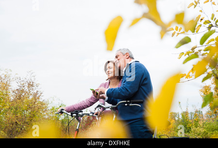 Couple with Bicycles using Cell Phone, Mannheim, Baden-Wurttmeberg, Germany Stock Photo