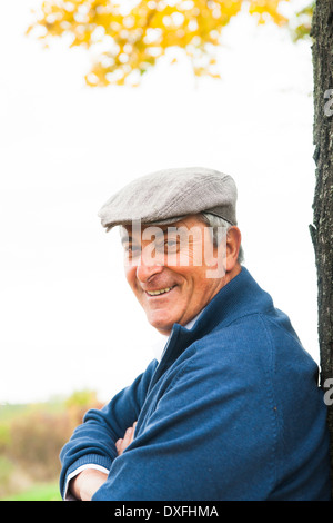 Senior Man leaning against Tree, Mannheim, Baden-Wurttemberg, Germany Stock Photo