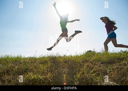 Girls Running and Jumping Outdoors, Mannheim, Baden-Wurttemberg, Germany Stock Photo