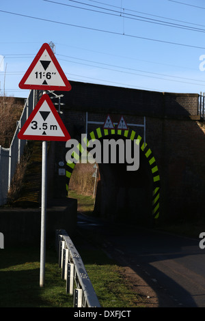 Railway bridge with height limit signs Stock Photo