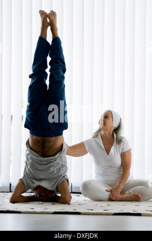 Mature couple doing yoga Stock Photo
