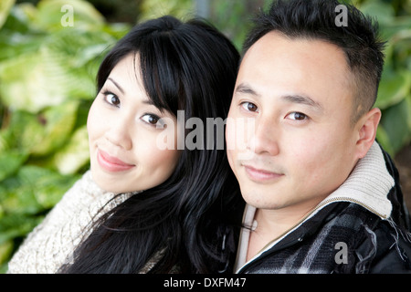 Close-up portrait of young couple outdoors, smiling and looking at camera, Ontario, Canada Stock Photo