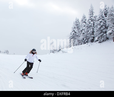 Mont-Tremblant , Quebec, Canada - February 9, 2014: A lonely skier is sliding down an easy slope at Mont-Tremblant Ski Resort. Stock Photo