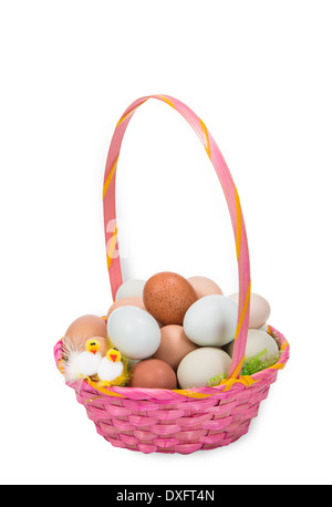 Pink Easter basket filled with colorful eggs and two decorative chickens, isolated on white Stock Photo