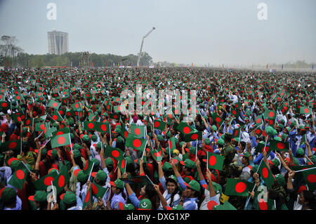 Dhaka, Bangladesh. 26th Mar, 2014. Bangladeshi people wave national flags as they gather to sing the national anthem at the National Parade Ground in Dhaka, Bangladesh, March 26, 2014. More than 254,681 people sang the national anthem together on the 43rd Independence Day to make history as the nation tried to create a Guinness record. Credit:  Shariful Islam/Xinhua/Alamy Live News Stock Photo