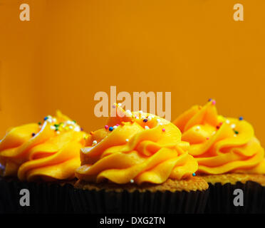 Trio Of Orange Iced Cupcakes In A Row Stock Photo