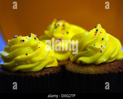Trio Of Yellow Iced Cupcakes In A Row Stock Photo