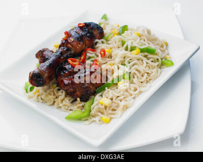 Noodles With Sticky Chicken Drumsticks Stock Photo