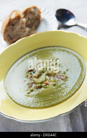 Bowl Of Pea And Ham Soup Served With Bread Stock Photo