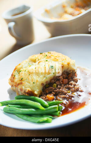 Plate Of Shepherds Pie With Green Beans Stock Photo