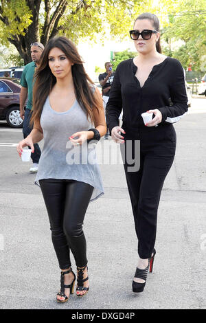 Kim Kardashian and Khloe Kardashian leaving a cafe with Cuban coffee, during filming for 'Kourtney and Kim Take Miami' Miami Florida - 13.10.12 Featuring: Kim Kardashian and Khloe Kardashian When: 13 Oct 2012 Stock Photo