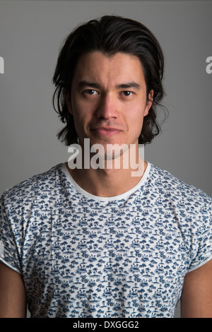 Portrait of handsome Malaysian man wearing flowery top and smiling Stock Photo