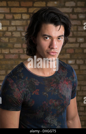 Portrait of handsome Malaysian man wearing flowery top Stock Photo