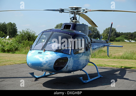 Pink Floyd drummer Nick Mason Aerospatiale AS 350 Squirrel helicopter, special paint work of pale blue sky with clouds Stock Photo