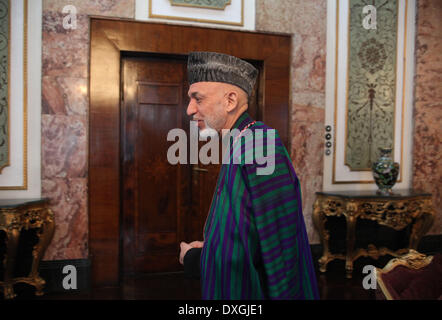 Kabul, Afghanistan. 26th Mar, 2014. Afghan President Hamid Karzai leaves after an interview with Xinhua News Agency at the presidential palace in Kabul, Afghanistan on March 26, 2014. Afghan President Hamid Karzai on Wednesday utterly rejected the rumors and reports suggesting he would sign the controversial Bilateral Security Agreement (BSA) with Washington before April 5 presidential elections to allow limited number of U.S. forces remain in Afghanistan after 2014 pullout of NATO-led troops from the militancy-plagued country. © Ahmad Massoud/Xinhua/Alamy Live News Stock Photo