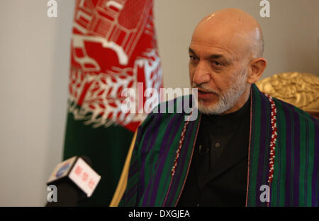 Kabul, Afghanistan. 26th Mar, 2014. Afghan President Hamid Karzai speaks during an interview with Xinhua News Agency at the presidential palace in Kabul, Afghanistan on March 26, 2014. Afghan President Hamid Karzai on Wednesday utterly rejected the rumors and reports suggesting he would sign the controversial Bilateral Security Agreement (BSA) with Washington before April 5 presidential elections to allow limited number of U.S. forces remain in Afghanistan after 2014 pullout of NATO-led troops from the militancy-plagued country. © Ahmad Massoud/Xinhua/Alamy Live News Stock Photo