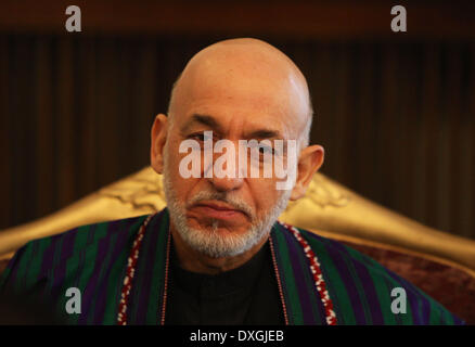 Kabul, Afghanistan. 26th Mar, 2014. Afghan President Hamid Karzai listens during an interview with Xinhua News Agency at the presidential palace in Kabul, Afghanistan on March 26, 2014. Afghan President Hamid Karzai on Wednesday utterly rejected the rumors and reports suggesting he would sign the controversial Bilateral Security Agreement (BSA) with Washington before April 5 presidential elections to allow limited number of U.S. forces remain in Afghanistan after 2014 pullout of NATO-led troops from the militancy-plagued country. © Ahmad Massoud/Xinhua/Alamy Live News Stock Photo