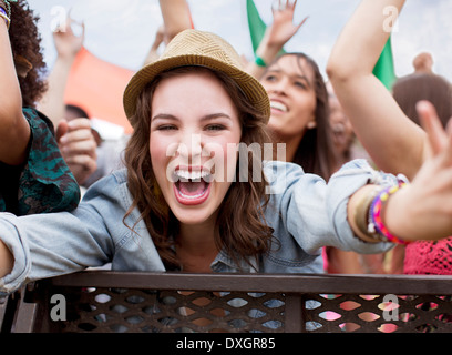 Close up of cheering woman at music festival Stock Photo