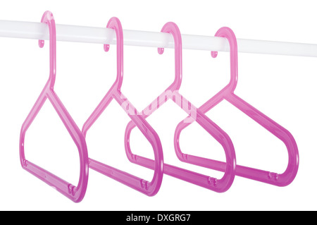 Pink plastic hangers hanging on a rod isolated on white background Stock Photo