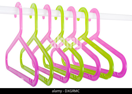 Colored plastic hangers hanging on a rod isolated on white background Stock Photo