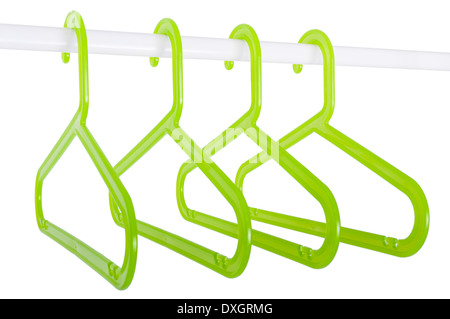 Green plastic hangers hanging on a rod isolated on white background Stock Photo